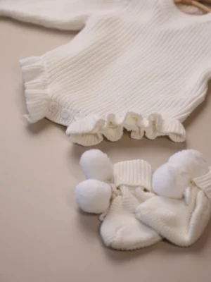 white_knit_ruffle_romper_buttons_detail